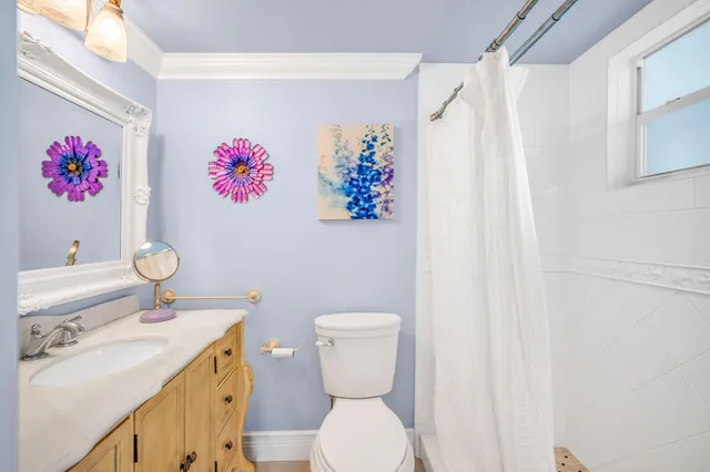 a bathroom with a sink toilet and mirror
