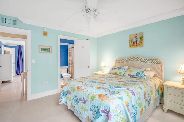 a white house with swimming pool in front of it