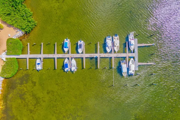 a wooden bench sitting in the middle of a yard