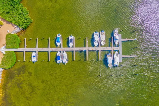 a wooden bench sitting in the middle of a yard