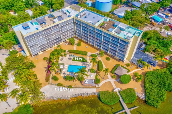 a living room with furniture and a painting on the wall