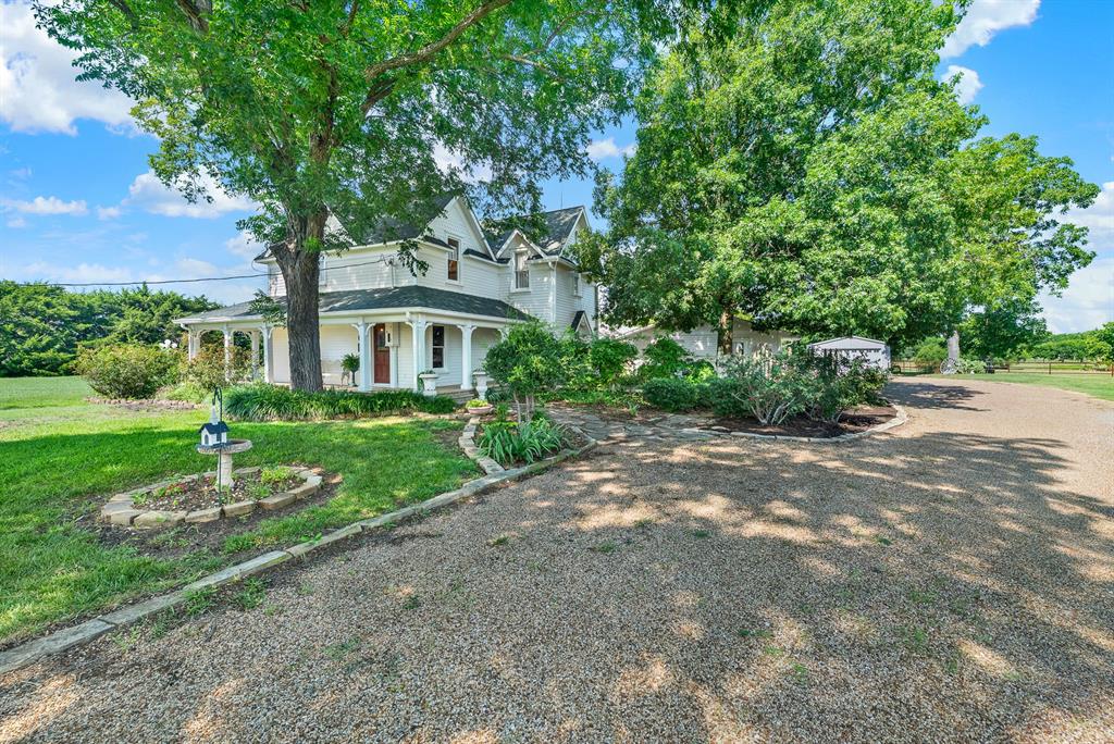 1425 Lone Star Road Celina, TX 75009 - Photo 25 of 40 The expansive gravel driveway provides exceptional off-street parking, easily accommodating residents, tenants, and guests. Towering shade trees and beautifully landscaped grounds create a memorable arrival while offering convenient access to every area of this unique 2.44-acre estate.