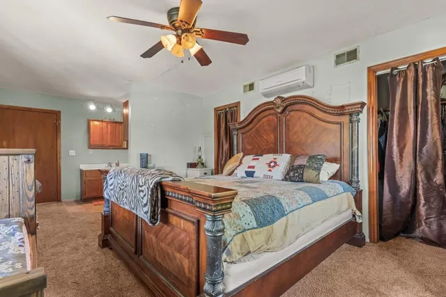 a living room with furniture a rug and a painting on the wall