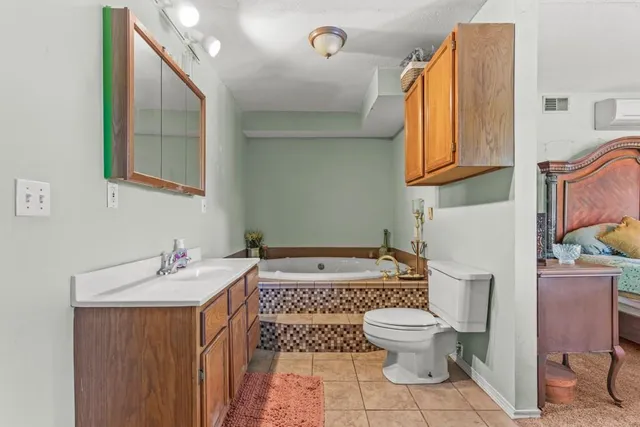 a bathroom with a sink toilet and mirror