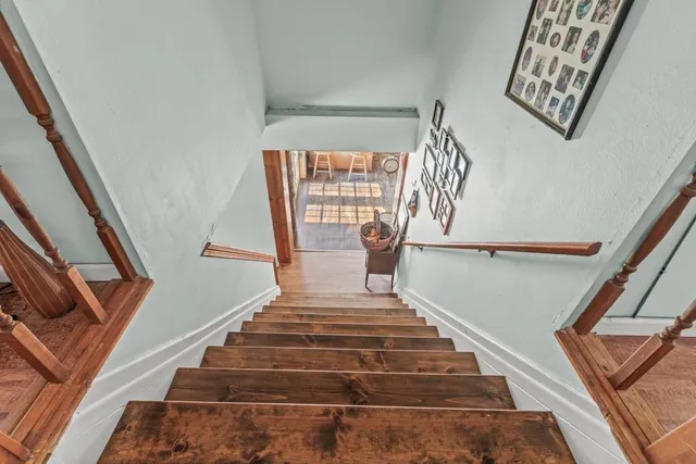 a view of staircase with wooden floor