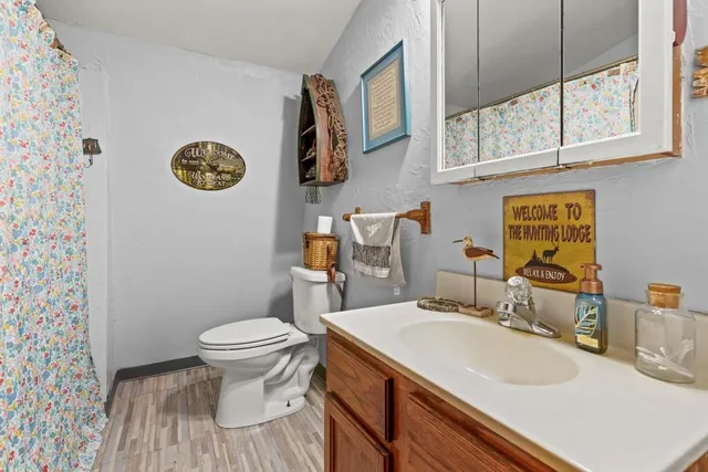 a bedroom with furniture and a wooden floor