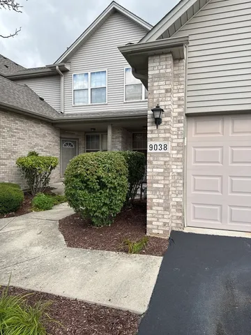 a front view of a house with a garage