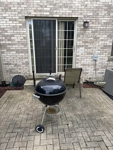a view of a backyard with furniture and a grill