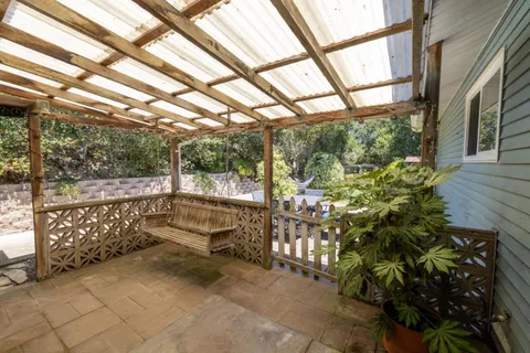 a view of backyard with deck and outdoor seating