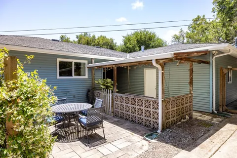 a view of backyard with sitting area