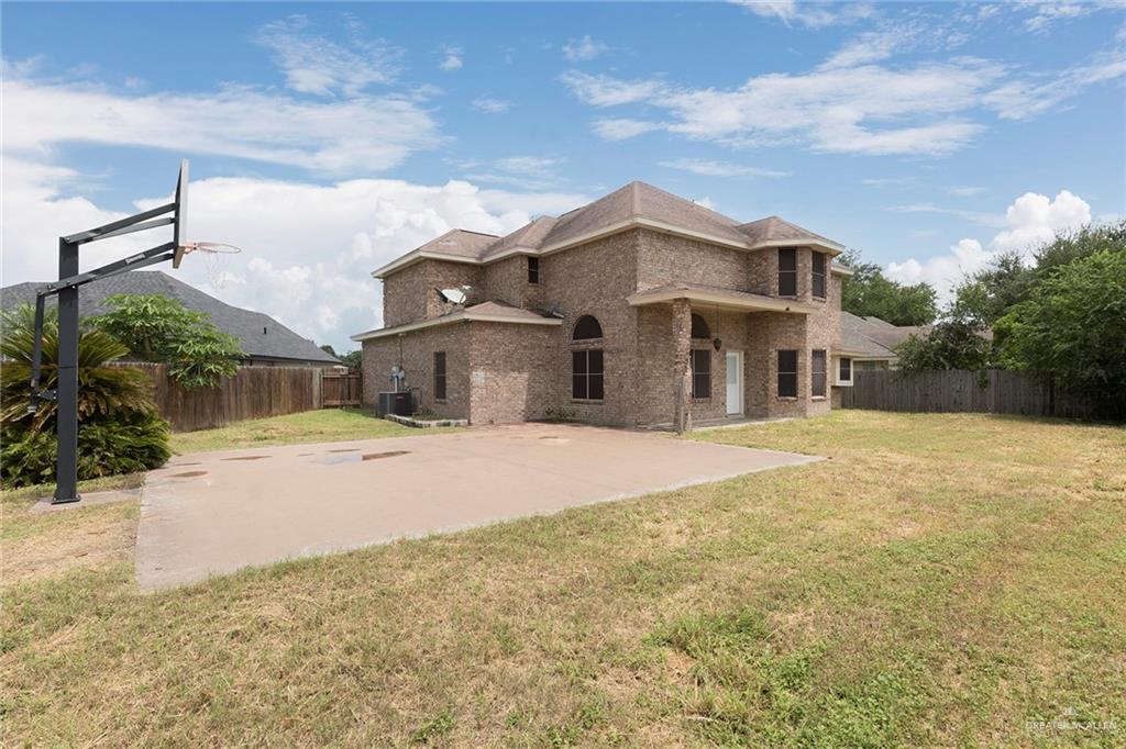 2001 Quail Lane Mission, TX 78572 - Photo 26 of 28 Spacious brick residence featuring a multi-level design, arched windows, and a covered patio area