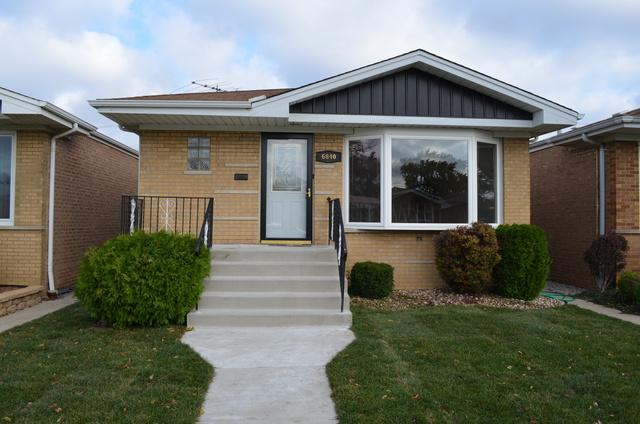 6840 West 64th Street Chicago, IL 60638 - Photo 1 of 19 a front view of a house with a yard