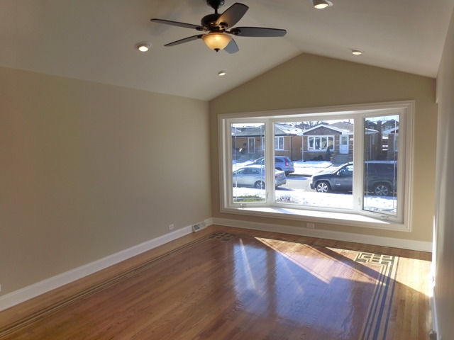 6840 West 64th Street Chicago, IL 60638 - Photo 2 of 19 a view of a livingroom with a window and wooden floor