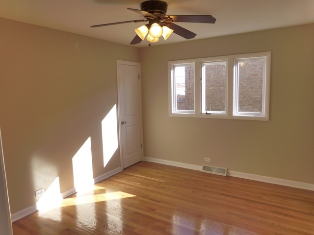 6840 West 64th Street Chicago, IL 60638 - Photo 15 of 19 a view of an empty room with wooden floor and a window