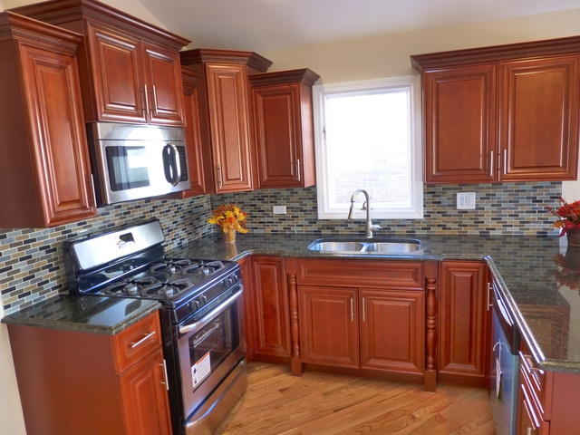 6840 West 64th Street Chicago, IL 60638 - Photo 16 of 19 a kitchen with stainless steel appliances granite countertop a stove a sink and a microwave