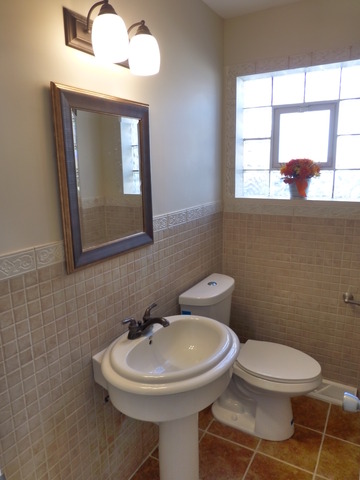6840 West 64th Street Chicago, IL 60638 - Photo 8 of 19 a bathroom with a toilet a sink and a mirror