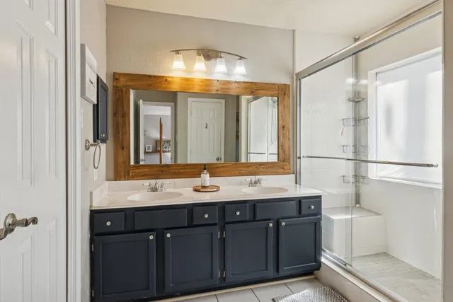 a bathroom with a shower and a sink