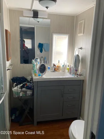 a bedroom with a bed and a mirror