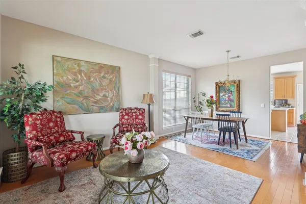 a living room with furniture a fireplace and a chandelier