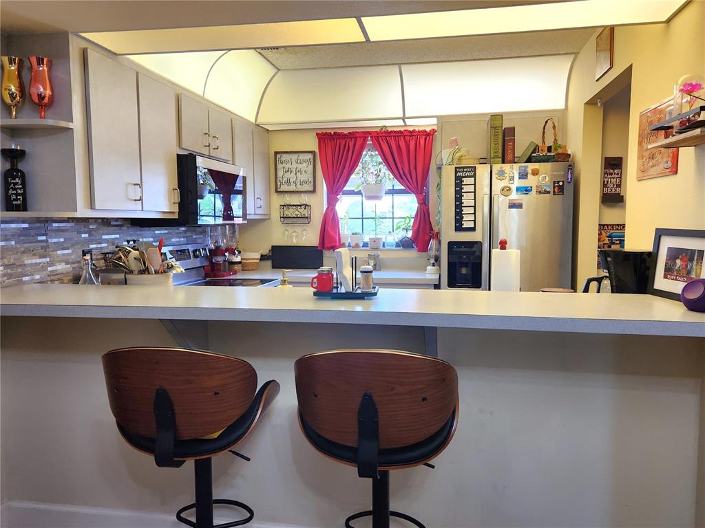 1701 Southeast 24th Road, Unit 1601 Ocala, FL 34471 - Photo 7 of 30 a kitchen with a sink a counter space and a window