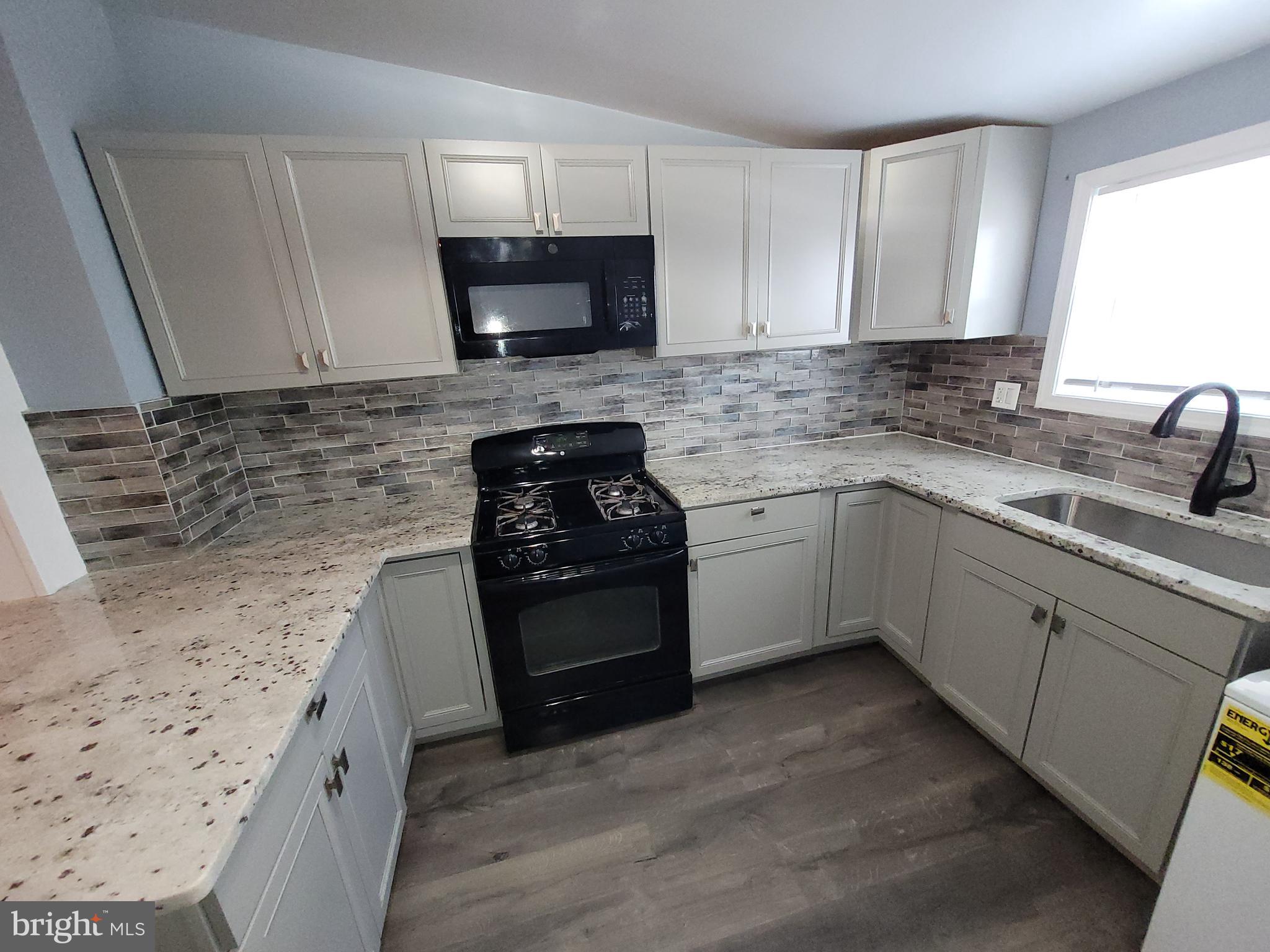 617 Archer Street Baltimore, MD 21230 - Photo 6 of 12 a kitchen with a sink stove and microwave