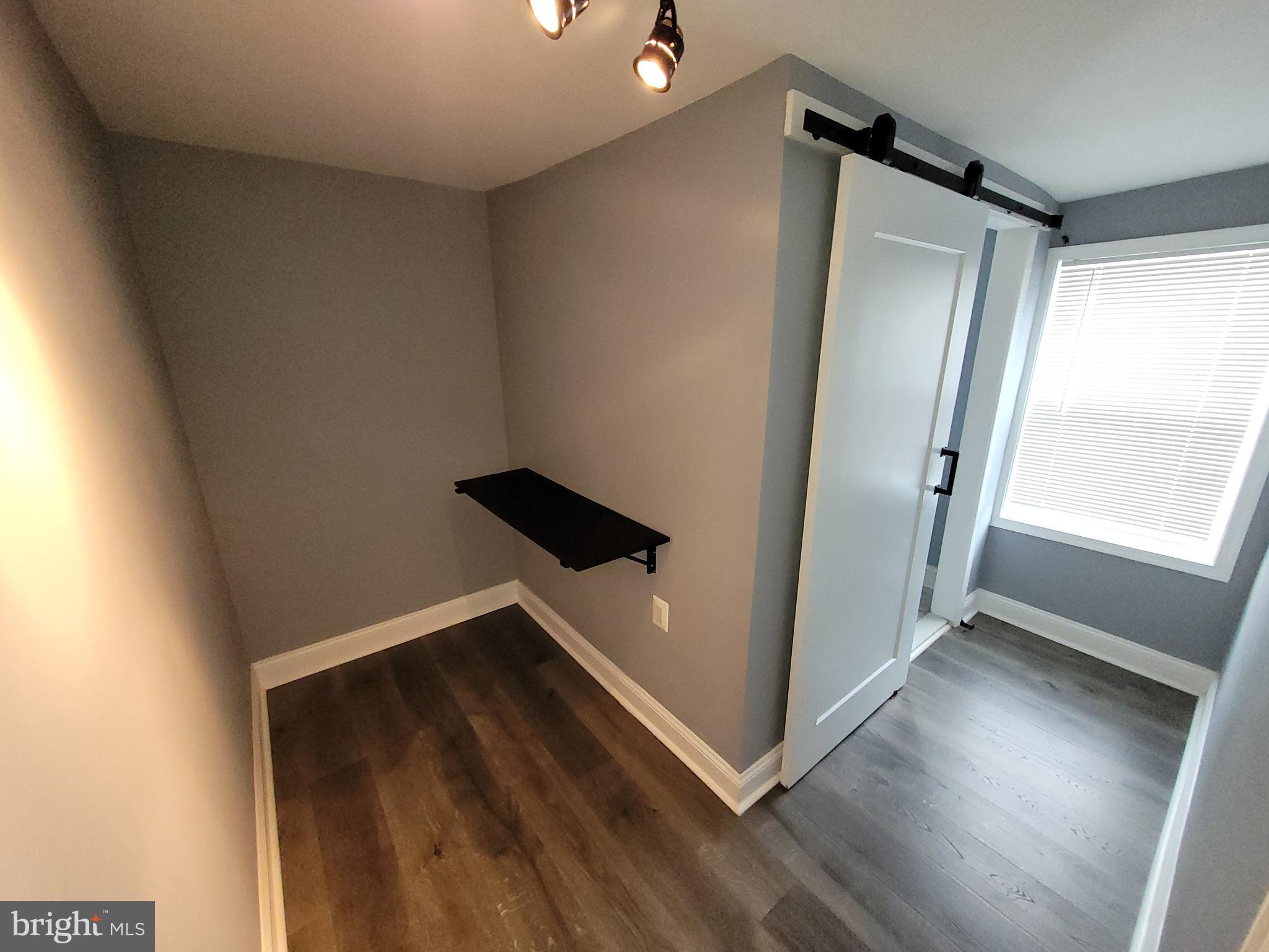 617 Archer Street Baltimore, MD 21230 - Photo 7 of 12 a view of an empty room with wooden floor and a window