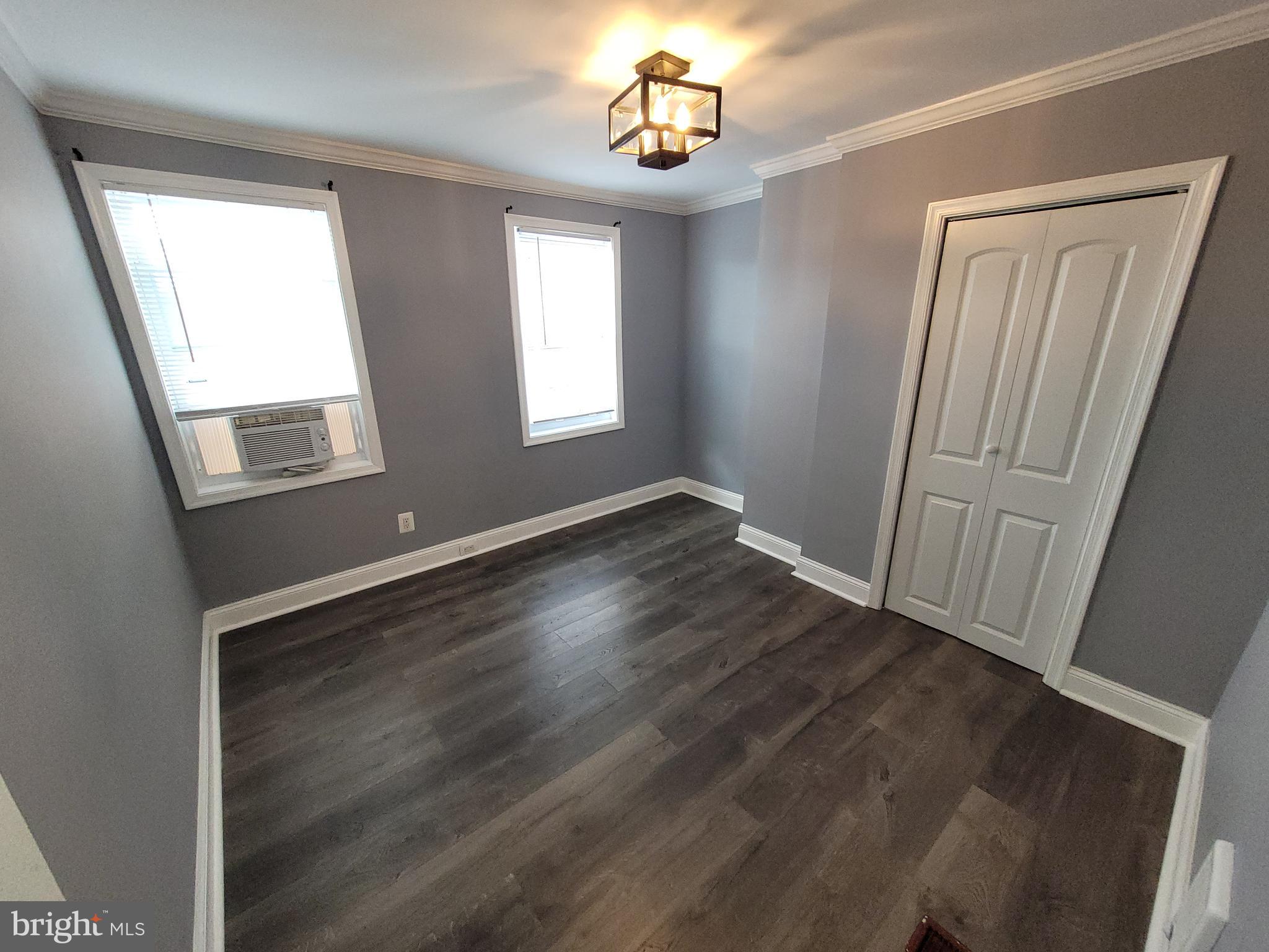 617 Archer Street Baltimore, MD 21230 - Photo 9 of 12 an empty room with wooden floor and windows