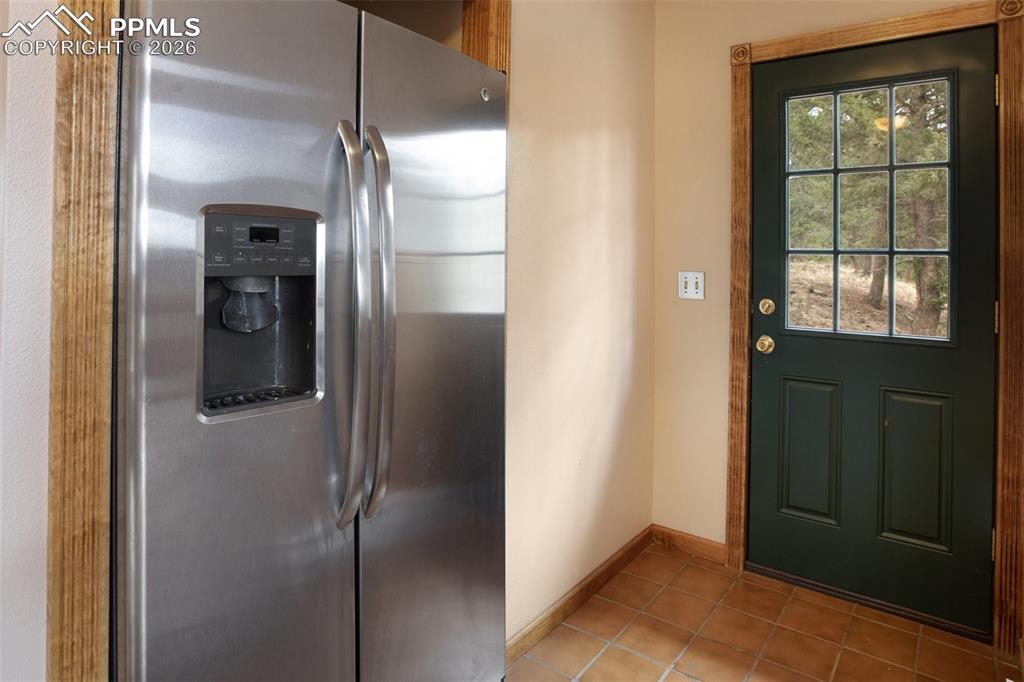 2061 Spruce Road Woodland Park, CO 80863 - Photo 12 of 26 a bathroom with a glass shower door and a mirror