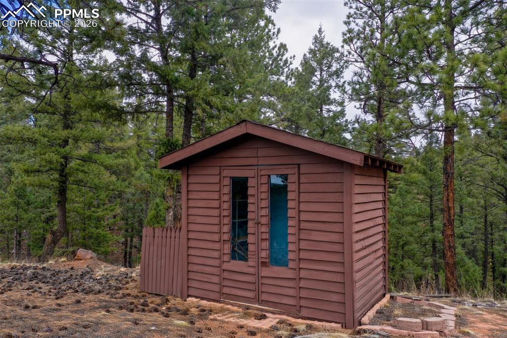 2061 Spruce Road Woodland Park, CO 80863 - Photo 24 of 26 a view of a small house with a tree in the background