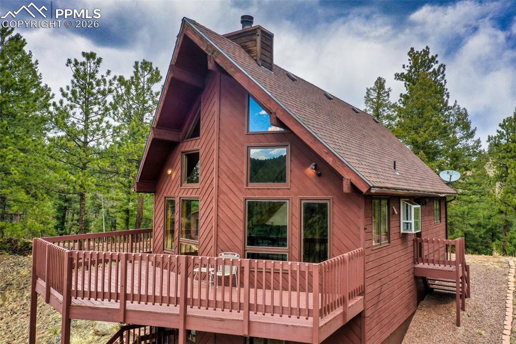2061 Spruce Road Woodland Park, CO 80863 - Photo 3 of 26 a view of a house with a deck and furniture