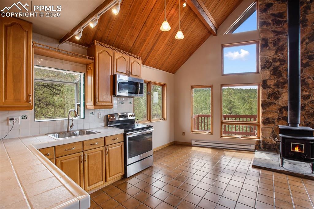 2061 Spruce Road Woodland Park, CO 80863 - Photo 8 of 26 a kitchen with a sink a stove and cabinets