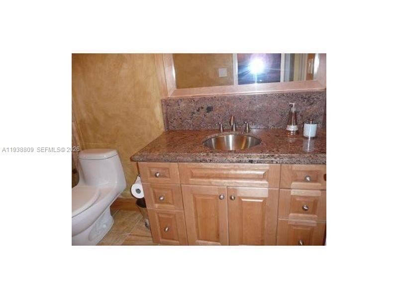 100 Lincoln Road, Unit 1631 Miami Beach, FL 33139 - Photo 11 of 30 a bathroom with a sink and a mirror