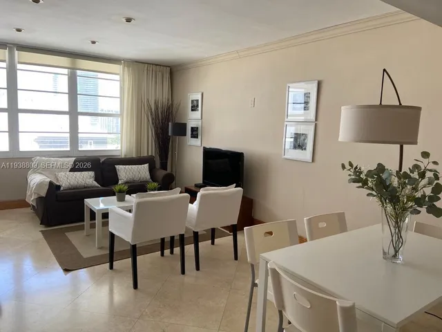 a view of a dining room with furniture and window