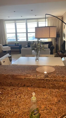 a kitchen with a sink a counter top space and cabinets