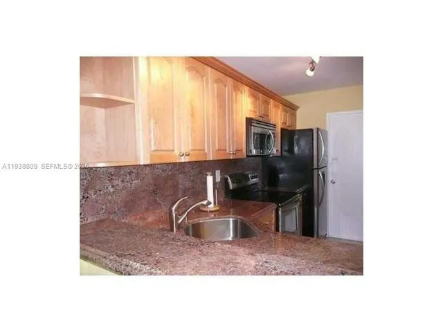 a kitchen with a sink and microwave