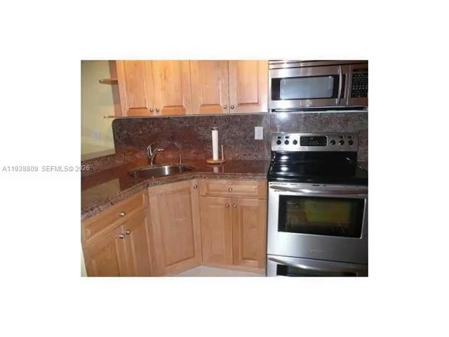 a kitchen with a stove and a microwave