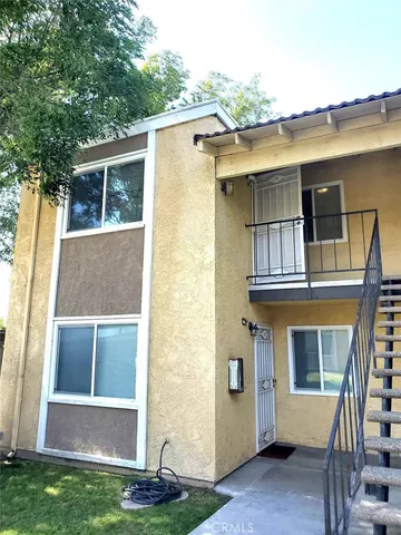 a view of front door of house with a yard