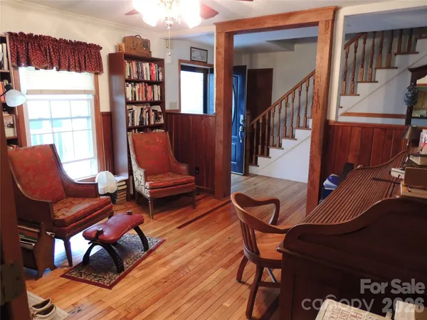 a living room with furniture a air conditioner and a window