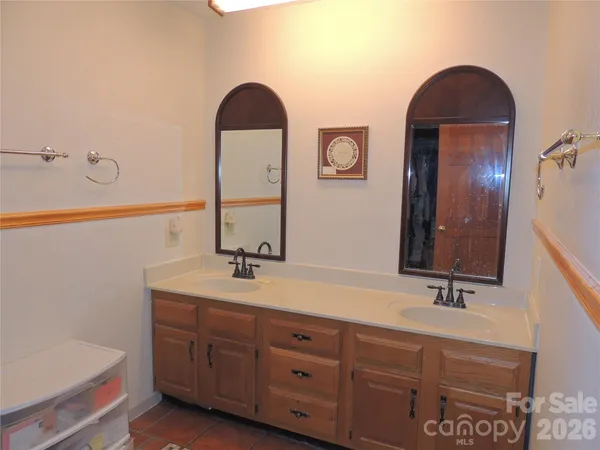 a bathroom with a double vanity sink and a mirror