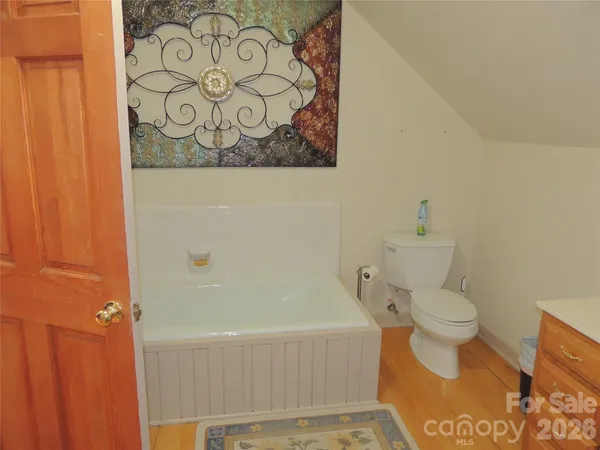 a bathroom with a toilet and a shower curtain