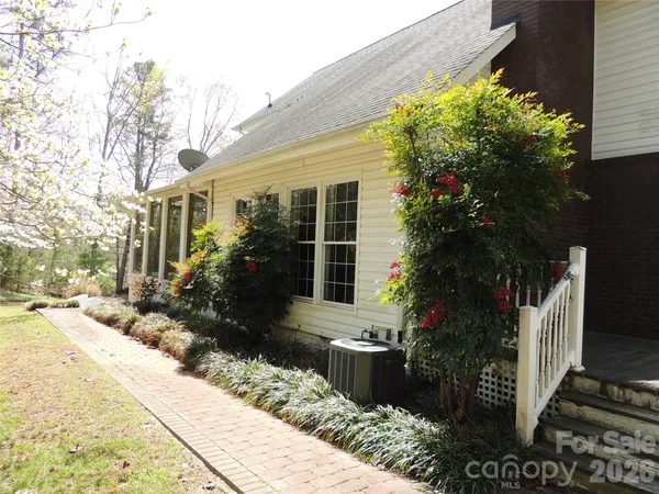 a front view of a house with a yard and trees