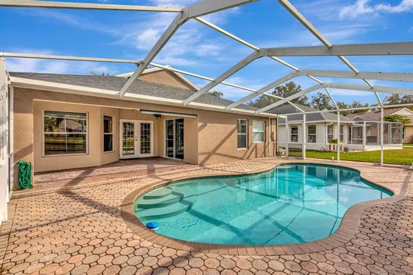 a view of a backyard with a swimming pool