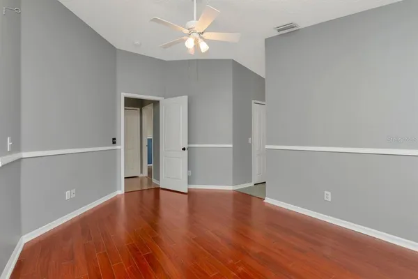 a view of an empty room and wooden floor