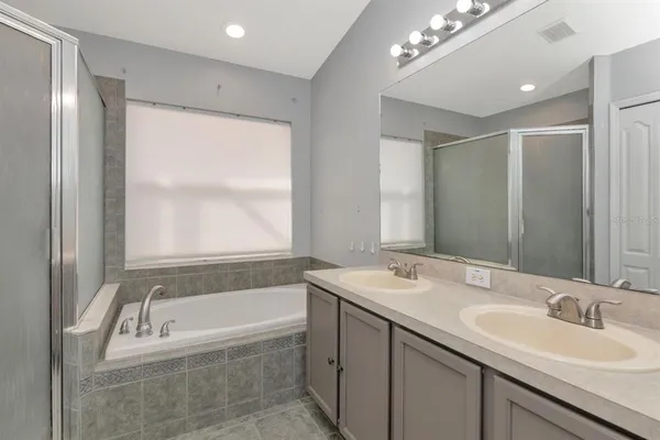 a view of an empty room with wooden floor and closet