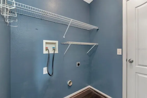 a front view of a house with a garden and trees