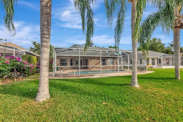 an aerial view of house with yard swimming pool and mountains