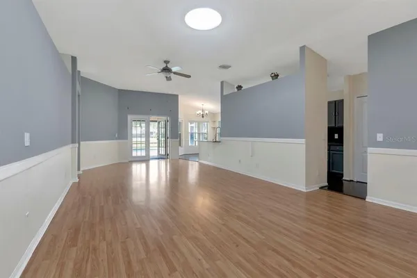 a kitchen with stainless steel appliances granite countertop a sink a stove and a wooden cabinets