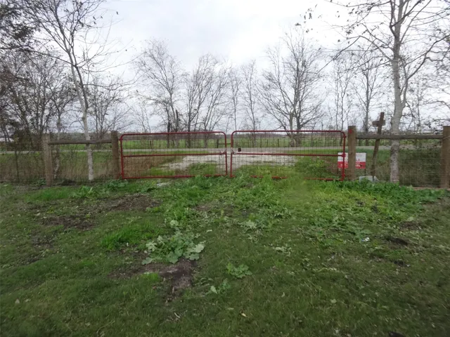 a backyard of a house with lots of green space and lake view