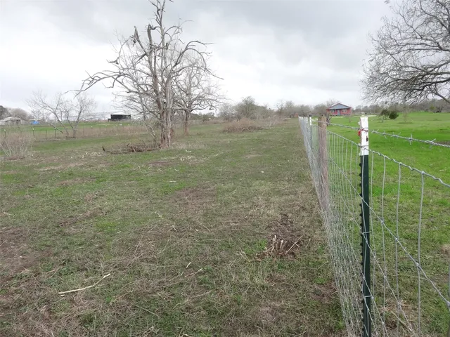 a view of a field with an ocean