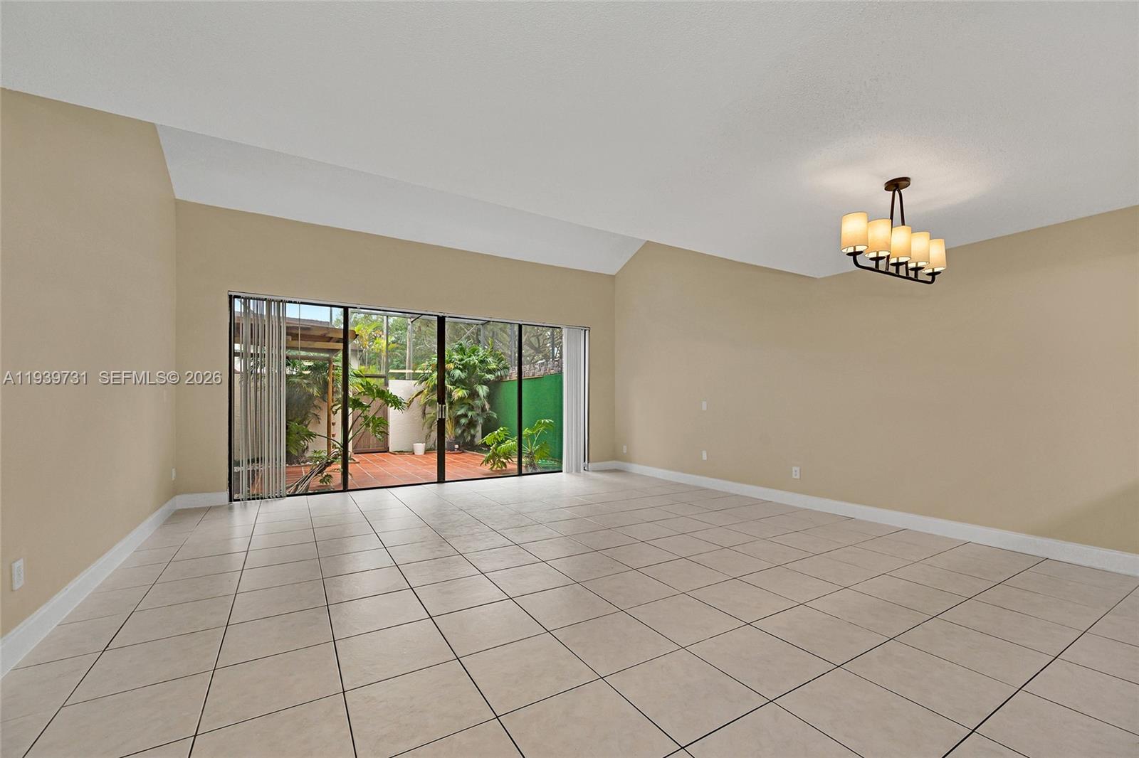 9079 Southwest 133rd Court, Unit F Miami, FL 33186 - Photo 14 of 34 a view of an empty room and window
